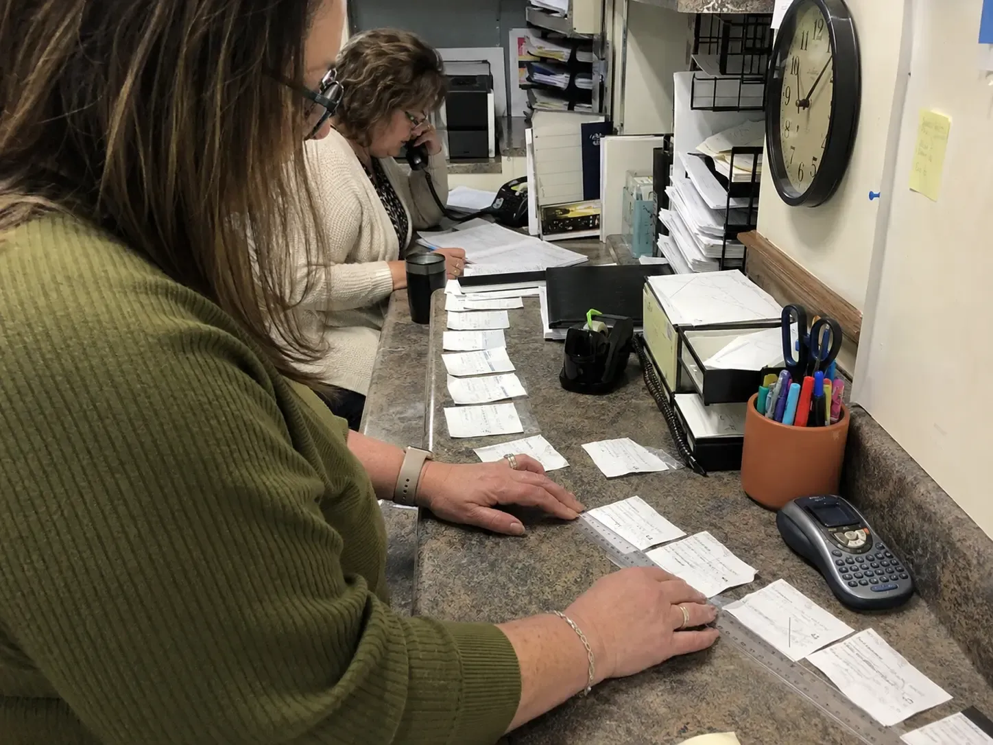 Two admissions coworkers auditing the steps between a website inquiry and a community tour